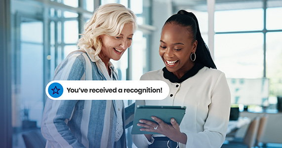manager and employee reviewing recognition message