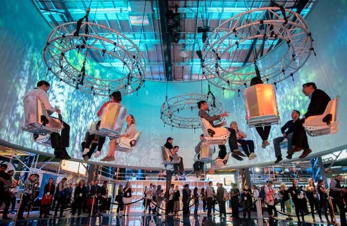 meeting event attendees sitting in suspended chairs