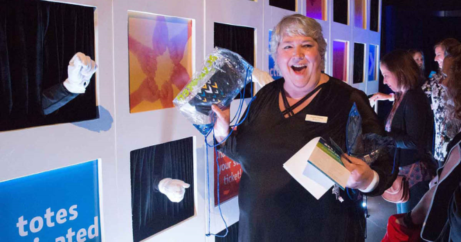 Event Activation Ideas woman receiving gift from hand wall activation
