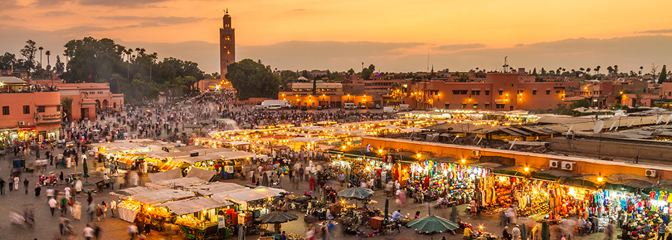 people walking and shopping in market square in Marrakech, Morocco