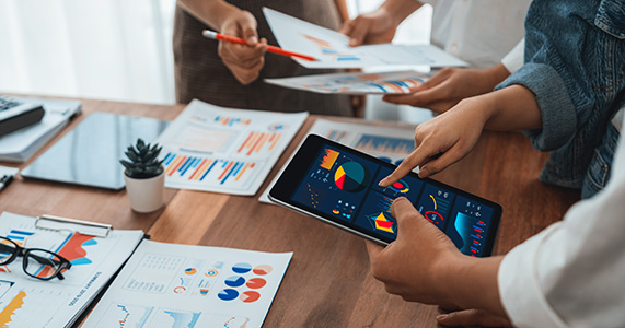 employees analyzing channel partner data on ipad