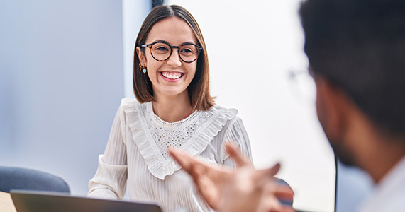 Happy employee in career development meeting with manager