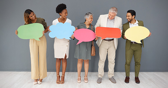 team of employees holding feedback bubbles