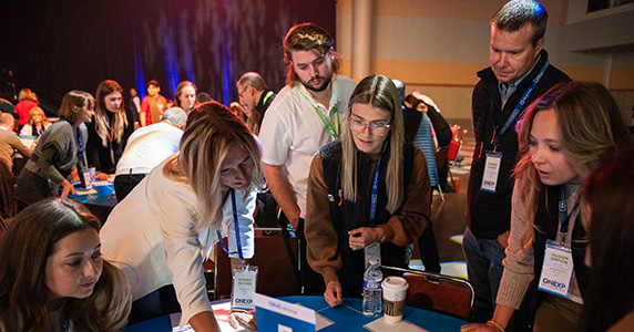 employees participating in hackathon activity at experiential event